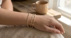 Model showcasing layered two-tone gold bracelets tailored for petite wrists