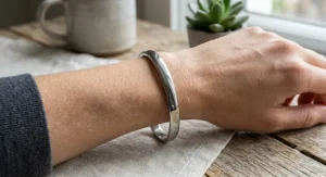 Minimalist polished stainless steel bangle bracelet with a sleek contour