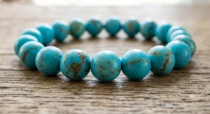 Close-up view of genuine turquoise beaded bracelet showing natural brown matrix line variations
