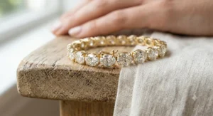 Close-up view of an oval-cut lab-grown diamond bracelet handcrafted in 18k yellow gold