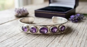 A sterling silver cuff bangle set with polished amethyst gemstones, perfect for a February birthstone present.