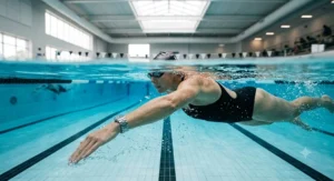 Swimmer doing laps in a pool while wearing a non-tarnish waterproof stainless steel bracelet.
