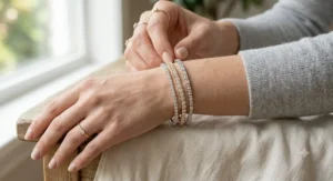 Woman stacking multiple delicate lab-grown diamond line bracelets for a chic layered jewelry look
