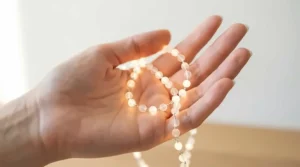 A person delicately holding a luminous akoya pearl bracelet in their palm