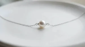 Minimalist freshwater pearl bracelet featuring a single floating pearl on a delicate silver chain.