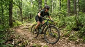 A mountain biker gripping handlebars while wearing a lightweight canvas bracelet for outdoor activities.