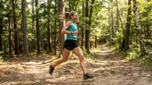 A runner sprinting down a forest path wearing a breathable canvas bracelet for outdoor activities.