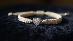 A delicate satin cord bracelet for prom featuring a sparkling silver charm paired with an evening gown.