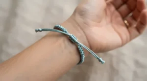 Detailed view of a vibrant satin cord bracelet for prom styled for a formal dance event.